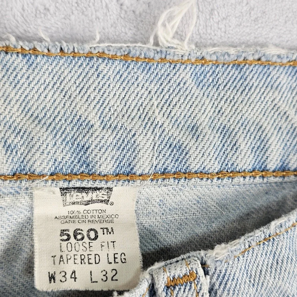 Vtg Levi's 560 Orange Tab Jeans 34x29 90s USA Loose Tapered Light Wash Raw Hem